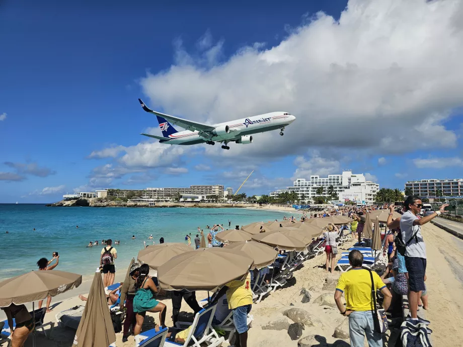 Sun umbrellas with sun loungers on Maho Beach